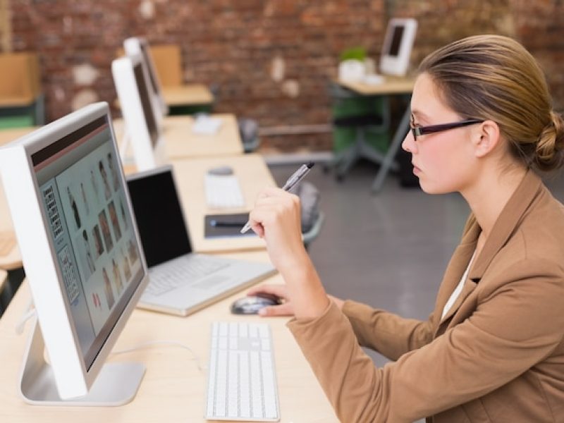 businesswoman-using-computer-office-desk_13339-72843