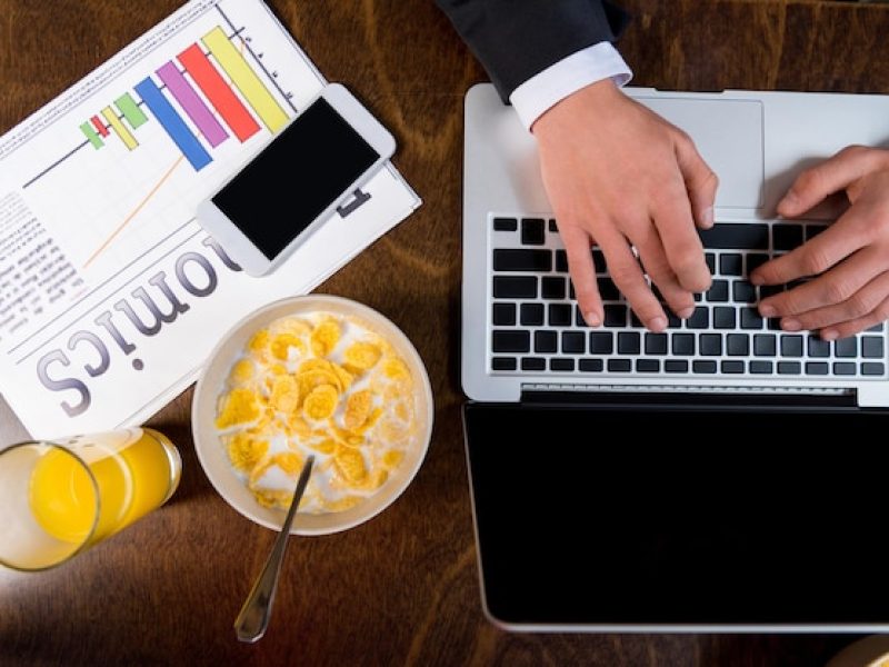 cropped-shot-businessman-using-laptop-while-having-breakfast_824701-1079