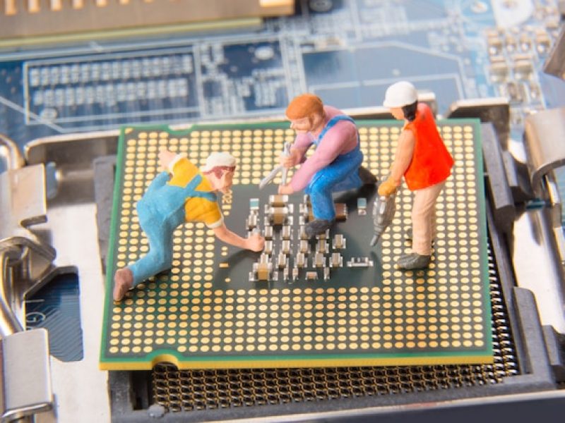miniature-engineers-technician-workers-repairing-cpu-motherboard_136401-1602