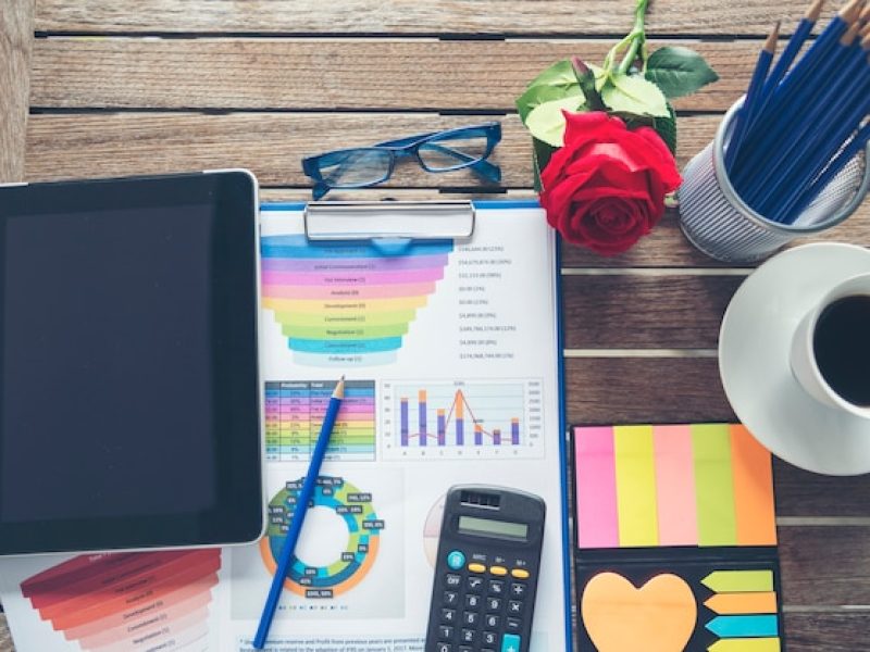 office-laptop-business-financial-document-chart-graph-wooden-table-with-coffee-cup_10139-701