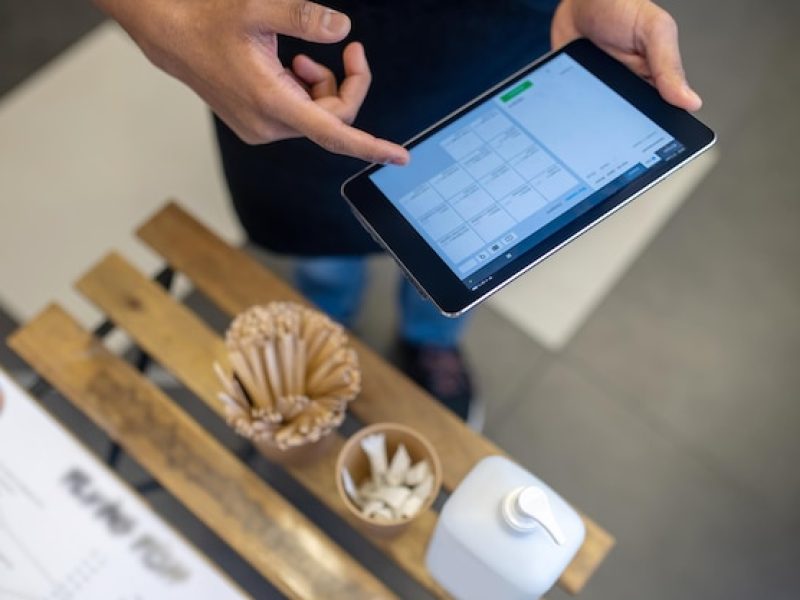 order-service-top-view-male-hand-touching-screen-tablet-pointing-choice-menu-cafe-without-face_259150-63578