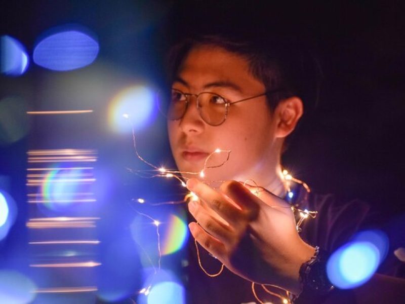 portrait-man-holding-illuminated-lighting-equipment-night_1048944-8927593