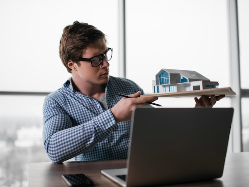 professional-architect-holding-model-house_207258-366