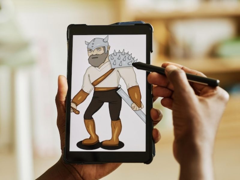 tablet-with-graphic-image-warrior-screen-hands-african-american-designer-using-stylus-wh_236854-45235