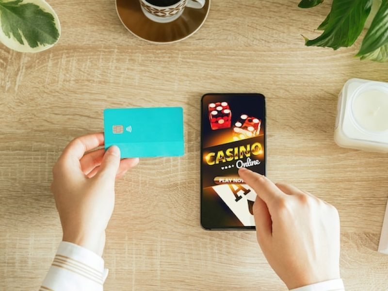woman-going-play-online-casino-from-her-living-room-holding-credit-card-pay_154993-722