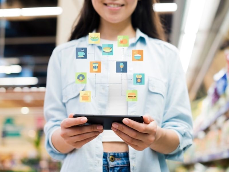 woman-using-smartphone-grocery-store_23-2148216090