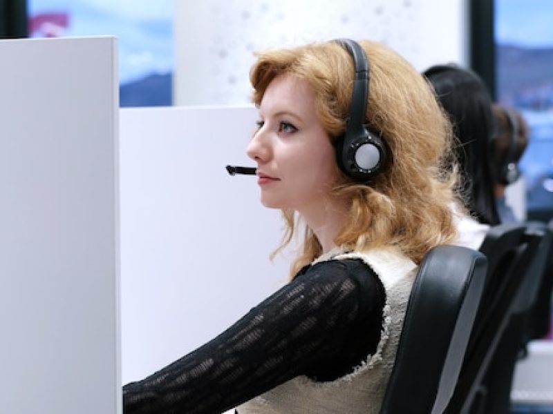 young-smiling-female-call-centre-operator-doing-her-job-with-headset_530697-41628